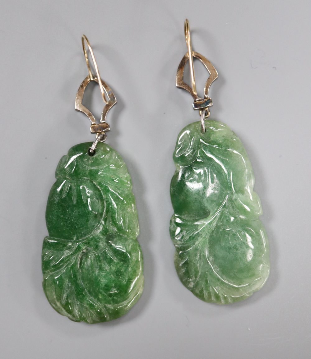 A pair of yellow and white metal mounted carved jade and diamond chip set earrings, jade 35mm, gross 14.6 grams.